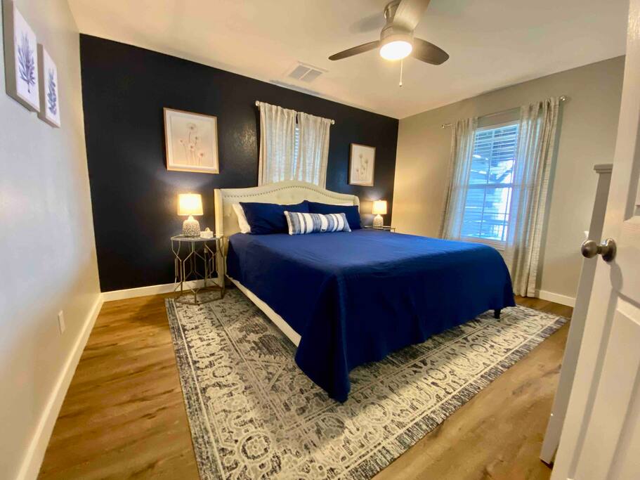 Primary bedroom has a King size bed, TV and small workspace.  Lake view from the bedroom window!