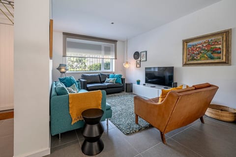 Living Room: Stylish retreat with vibrant decor, plush seating, and a sunlit view—perfect for relaxing!