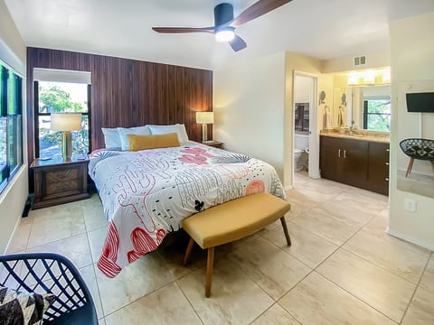 Main bedroom with a luxurious king bed, walk-in closet, private full bathroom, and a Roku TV, ensuring comfort and convenience for a relaxing stay.