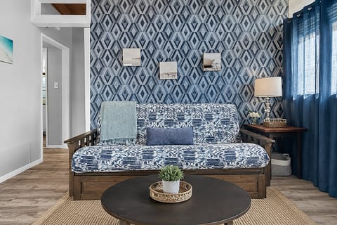 Relax in the cozy living room, complete with a full futon and smart TV, perfect for winding down after a day in the sun