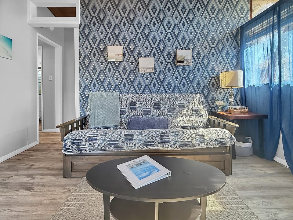 Relax in the cozy living room, complete with a full futon and smart TV, perfect for winding down after a day in the sun