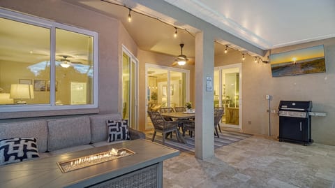 Covered patio with fire pit, dining area & BBQ—perfect evenings