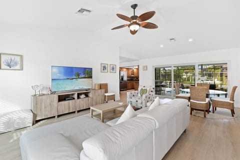Unwind in a Chic Space with a Brand-New Sofa and Thoughtfully Selected Furniture, Offering Picturesque Views of the Pool and Scenic Canal.