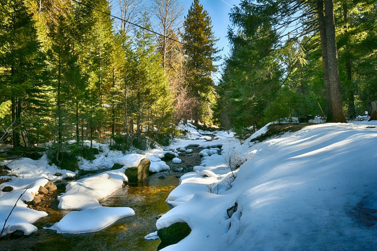 The all season Bailey Creek flowing through winter snow on a crisp and sunny winter day. Lassen creekside cabin