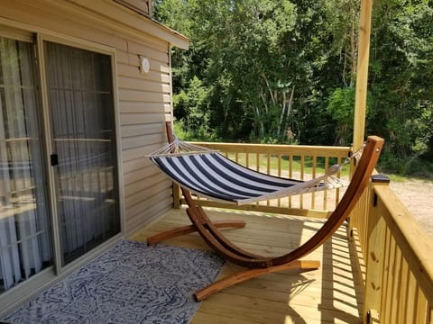 Sliding glass door into the living room and hammock on front porch.