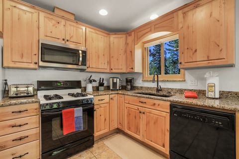 Gather, cook, and connect in this inviting kitchen. Amenities include gas stove, microwave, dishwasher and full-sized refrigerator. Keurig coffee machine and drip coffee maker. Toaster, rice cooker, dinnerware provided.