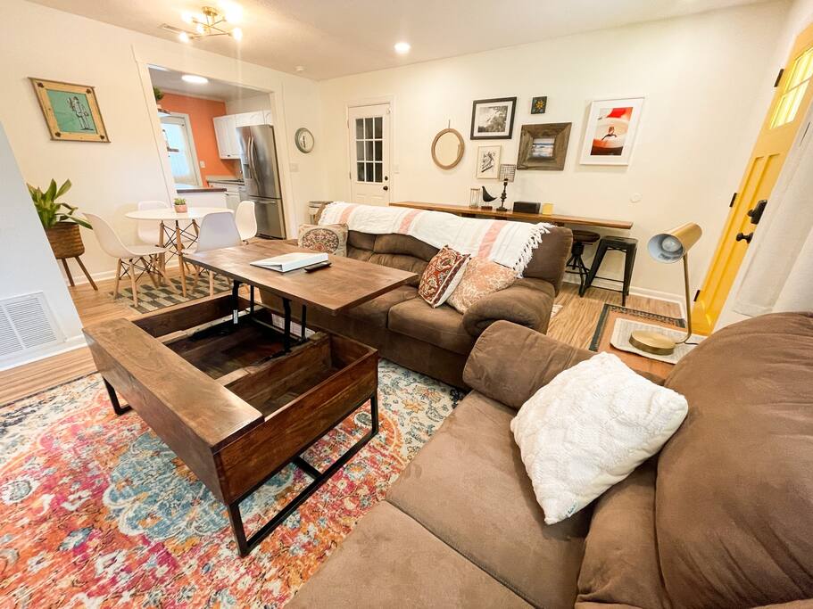 The coffee table converts into additional dining space. - The Mint - Fort Walton Beach