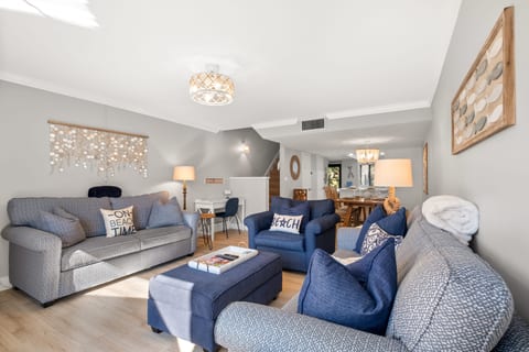 Spacious living room, desk and steps leading to 2nd floor