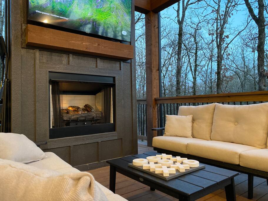 Warm and inviting cabin living space with a stone fireplace and cozy seating.