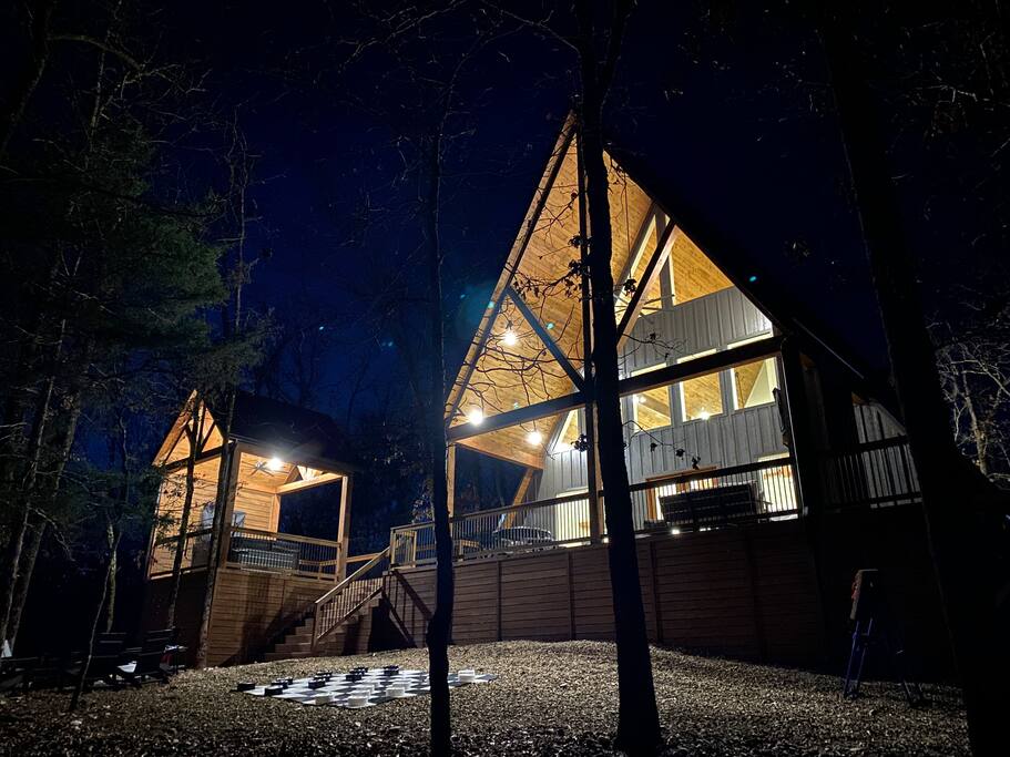 Tranquil A-frame cabin with warm lighting in Hochatown.

