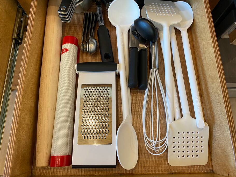 Organized kitchen drawer with essential cooking tools.