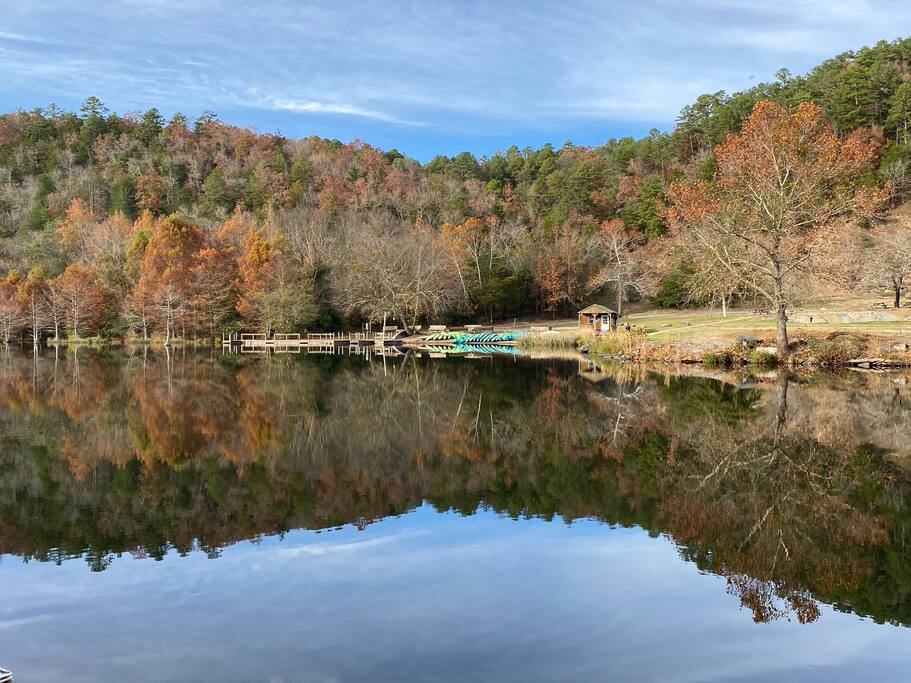 Serene lakeside view with autumn foliage and perfect water reflections in Broken Bow / Hochatown, Oklahoma.