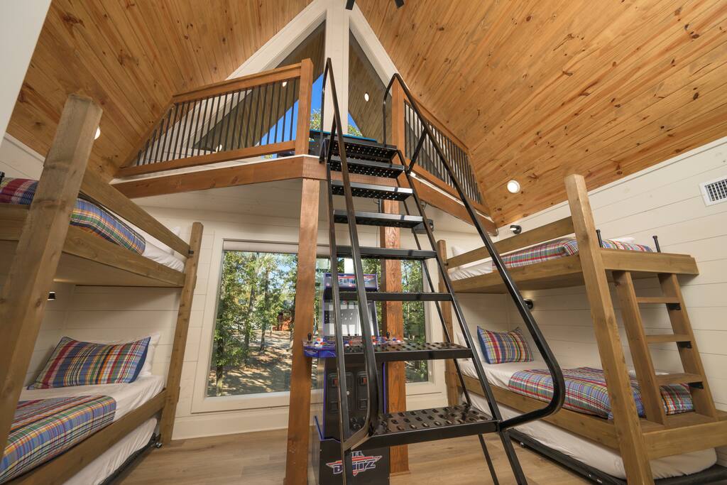 Cozy cabin vibes with rustic bunk beds, loft charm, and scenic window views.