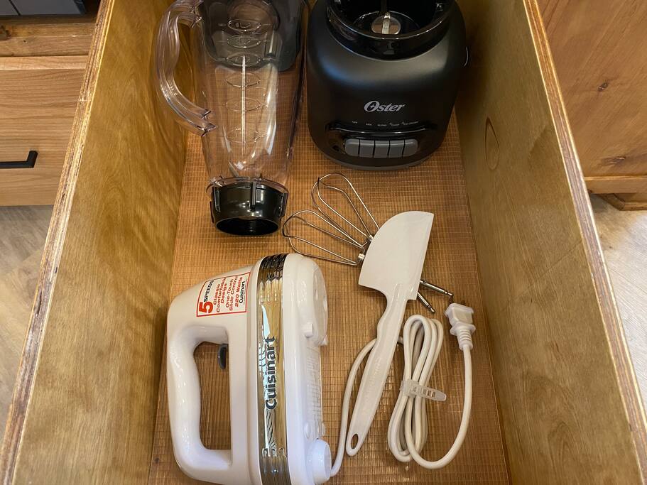 Organized drawer with blender, hand mixer, and baking essentials.