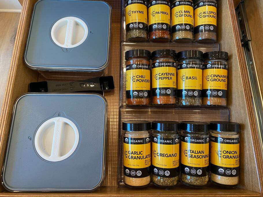 Rustic spice drawer with neatly labeled organic jars.