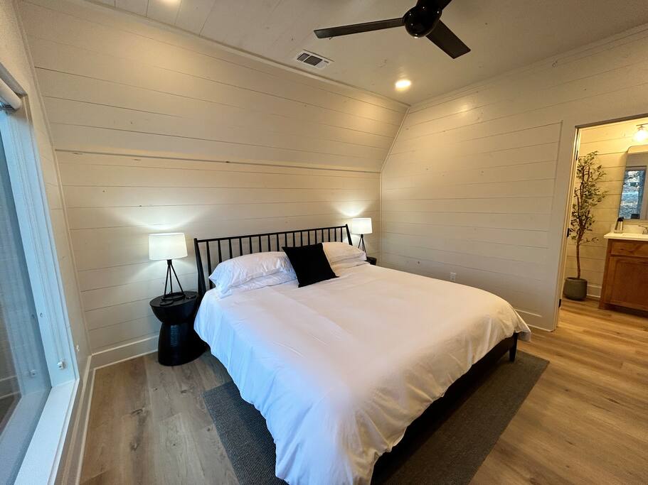 Cozy modern bedroom with a king-size bed and stylish decor.