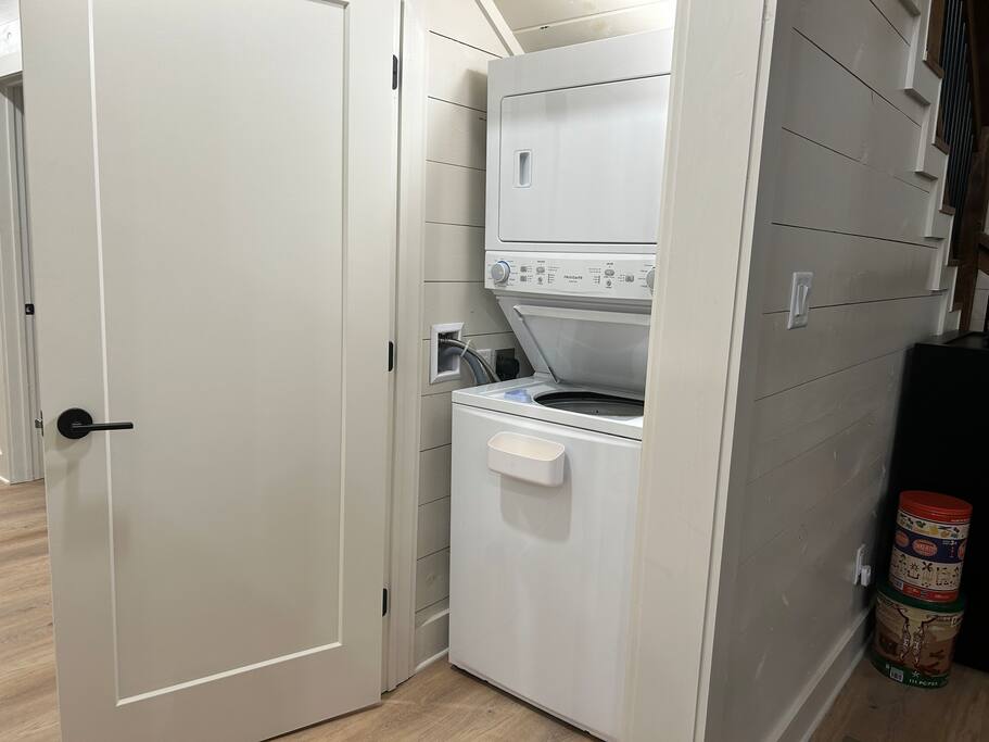 Space-saving laundry nook with stacked appliances—efficient and cozy home vibes.