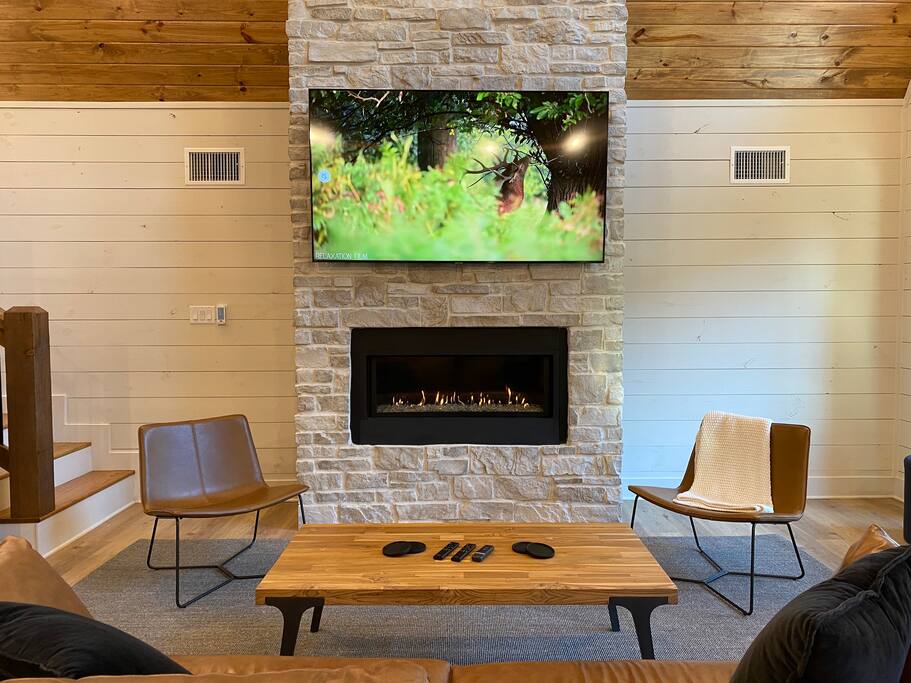 Cozy outdoor patio with a fireplace, comfy seating, and nature views!