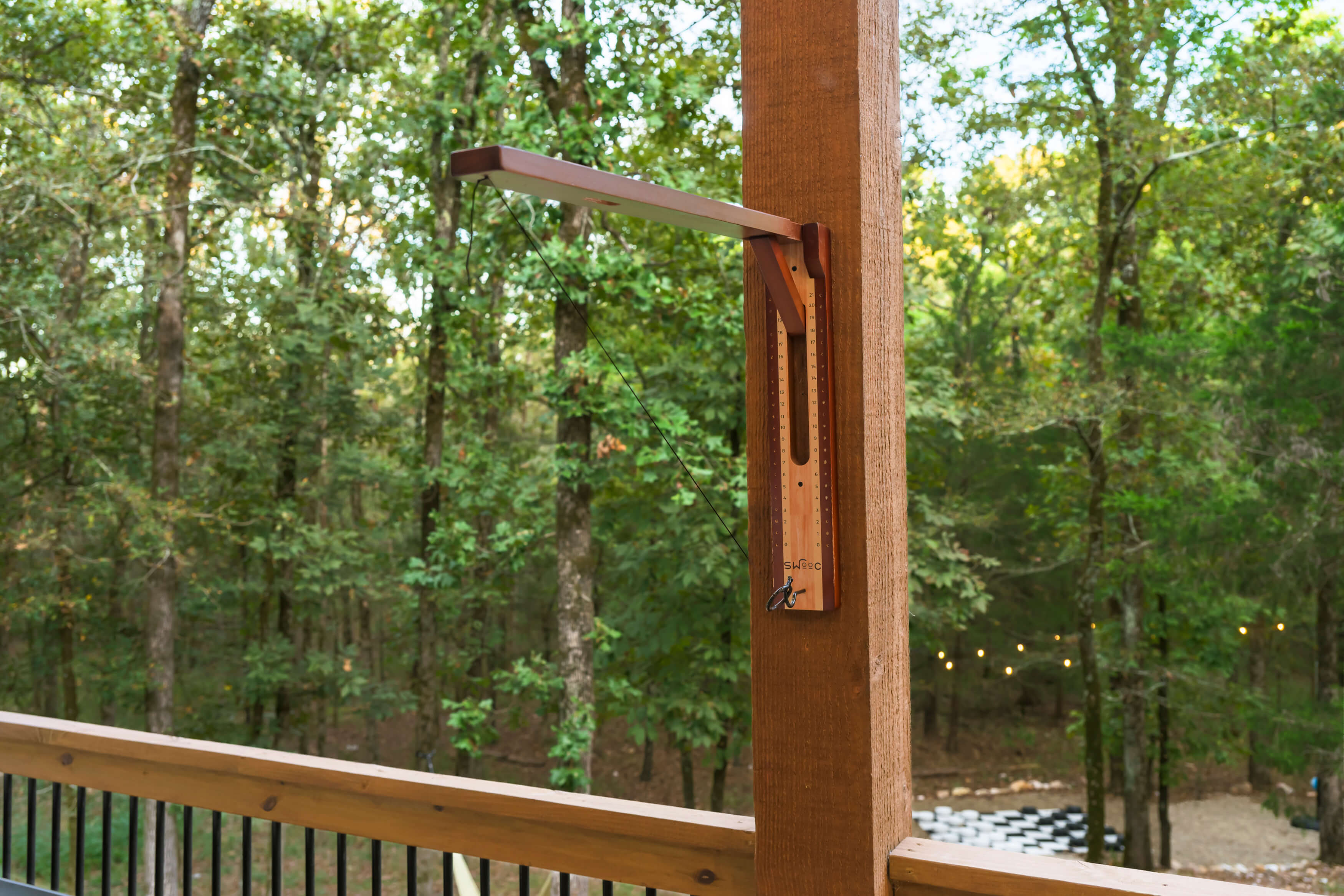 Guest laying on a large floating hammock with the lush green forest in the background.