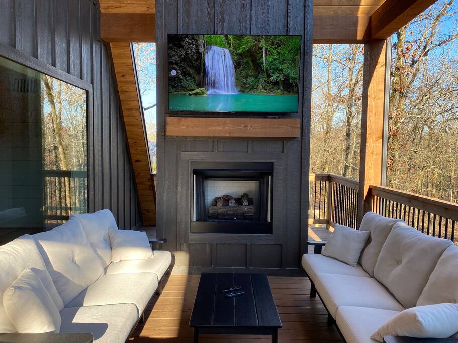 Spacious modern cabin with cozy seating, open kitchen, and warm wood accents.