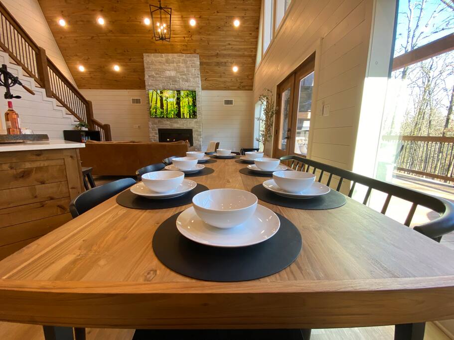 Elegant rustic dining setup with cozy cabin vibes and scenic views.