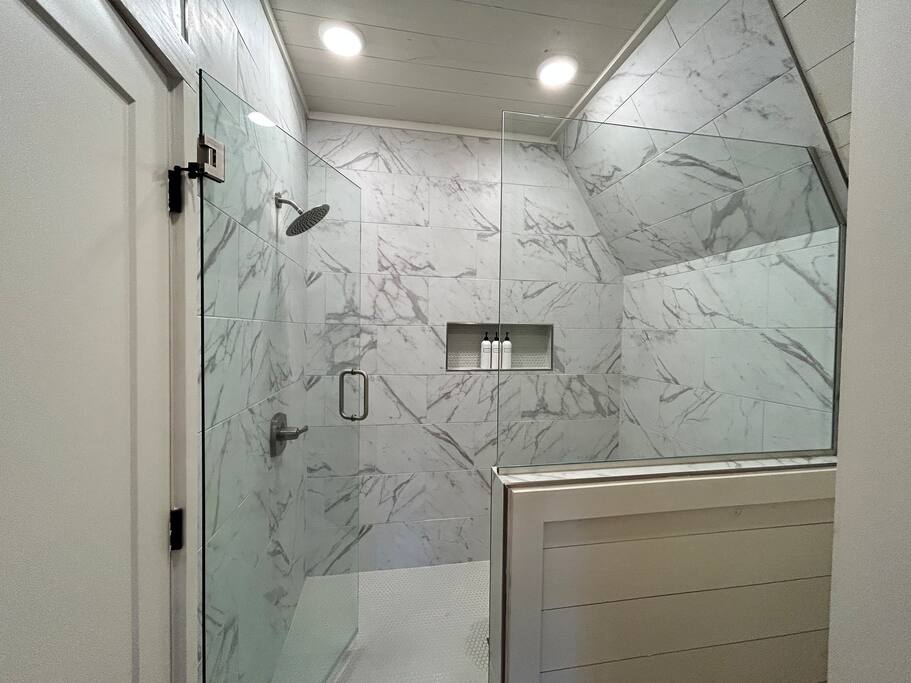 Modern rustic bathroom with a spa-like shower and elegant farmhouse decor.