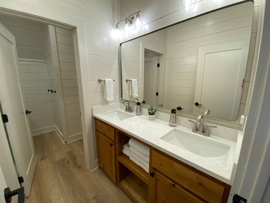 Contemporary bathroom with double sink vanity and stylish lighting.