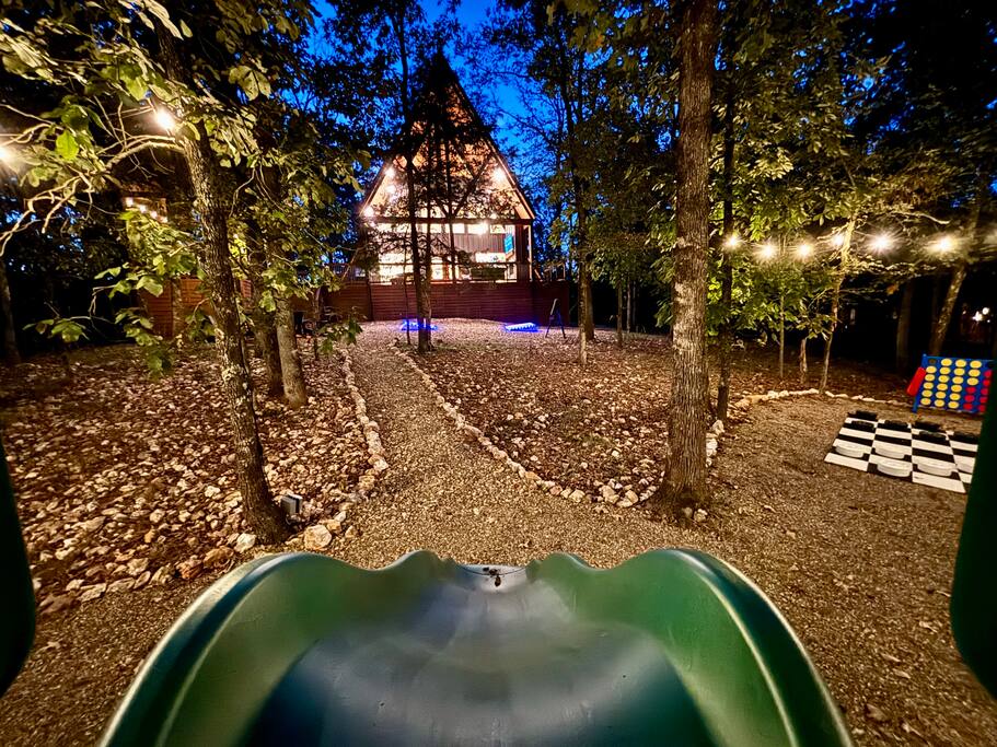 Relaxing cabin retreat with volleyball setup amidst serene forest scenery.