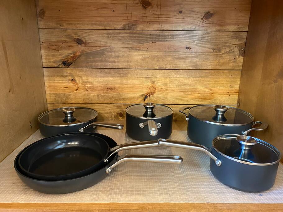 Premium cookware displayed in a cozy wooden kitchen setting.