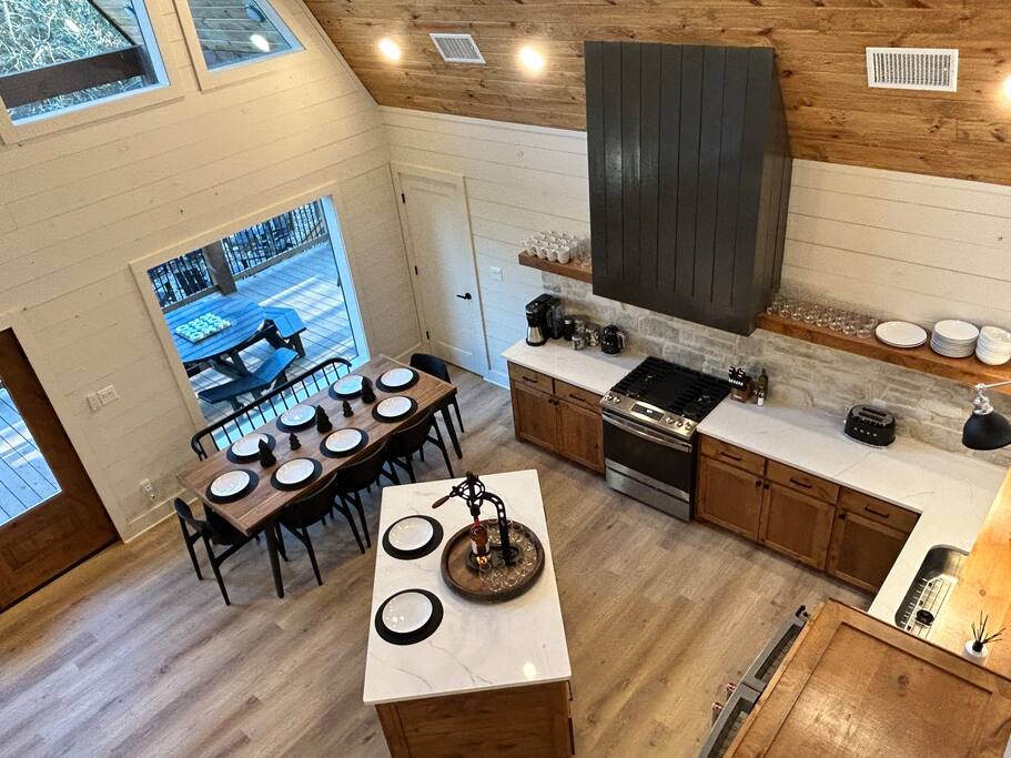 Modern kitchen with rustic charm and outdoor deck views.
