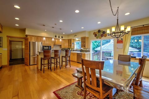 Dining and full kitchen with sit up bar on main living floor. Walk out to deck that includes a hot tub and gazebo with bbq and seating down below.