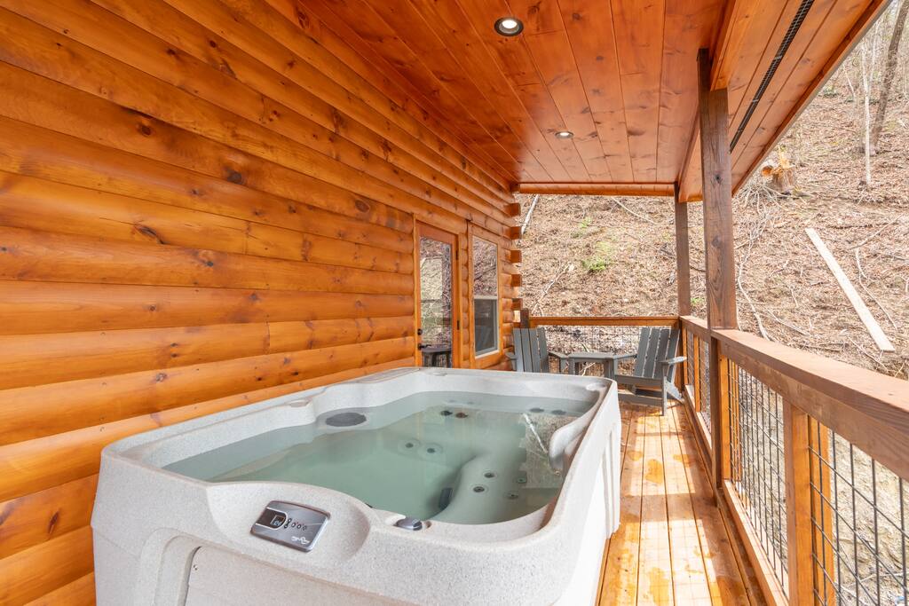 The upper deck hot tub is a haven of relaxation. Elevated views complement the bubbling warmth, offering a serene escape amidst nature's beauty. Perfect for unwinding under the open sky, it's a luxurious touch to elevate your cabin experience.