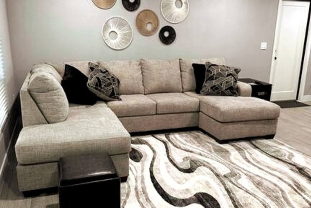 Looking from the front door. Brand new sectional in living room. Ceiling fan