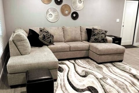 Looking from the front door. Brand new sectional in living room. Ceiling fan
