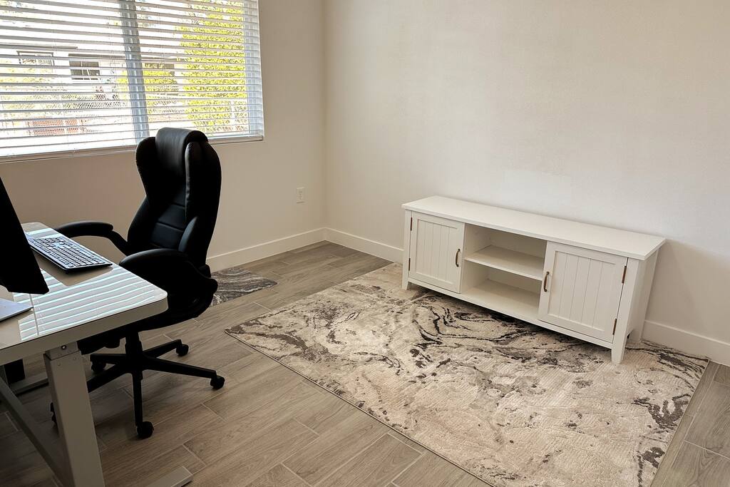 3rd bedroom set up as office.  Sit/stand desk, comfort mat and office chair.  23" extra monitor & HDMI cord to plug into your laptop as well as additional full sized keyboard and mouse available.  Cei