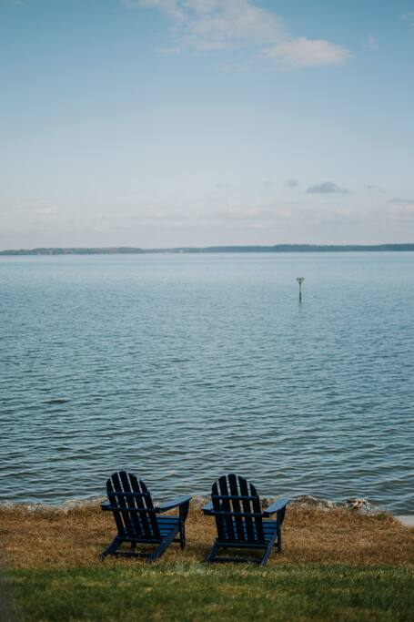 Take a seat right by the water. It's the perfect spot for a book and a cool drink while watching the rest of the family play in the river. - Cozy Waterfront Getaway Fireplace/Kayaks/Fire Pit - Locust Hill