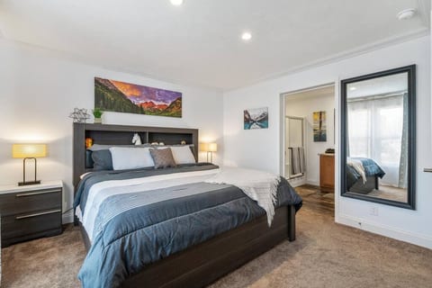 Master bedroom with luxurious king bed, full-size dresser, walk-in closet, two large mirrors, and touch-control lamps with charging ports and wireless charging. Stylish blackout curtains.
All bedrooms feature full-length mirrors.