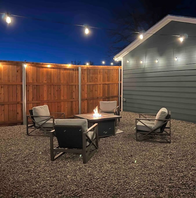 Backyard firepit oasis with yard games and high-definition outdoor projector to host family movie night or watch the big game.