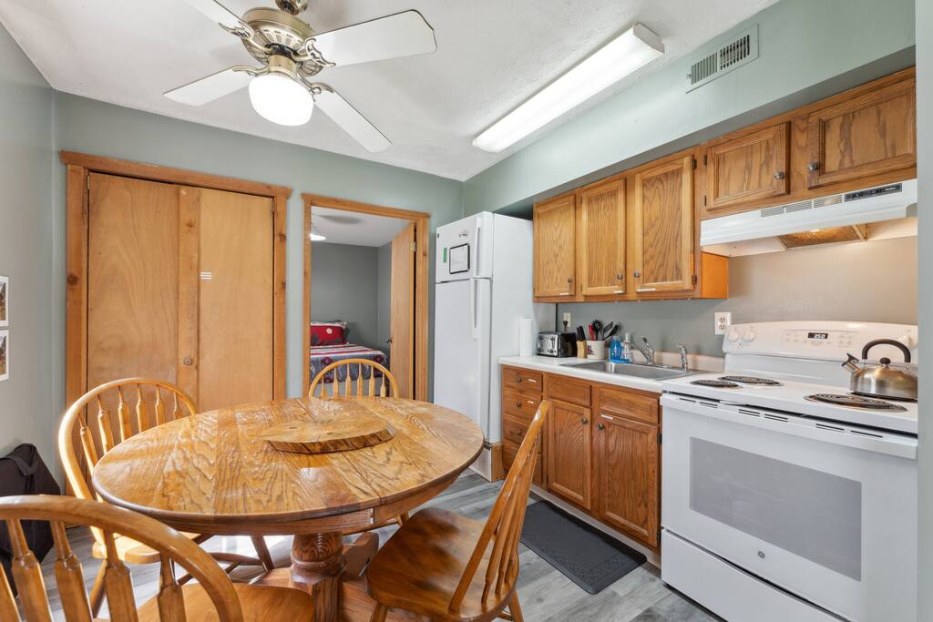 The cabin kitchen has a table and chairs. There is also a card table in the main-level bedroom closet. The cabin kitchen has a table and chairs. There is also a card table in the main-level bedroom closet. - Eagle Bluff Estate - Mauston