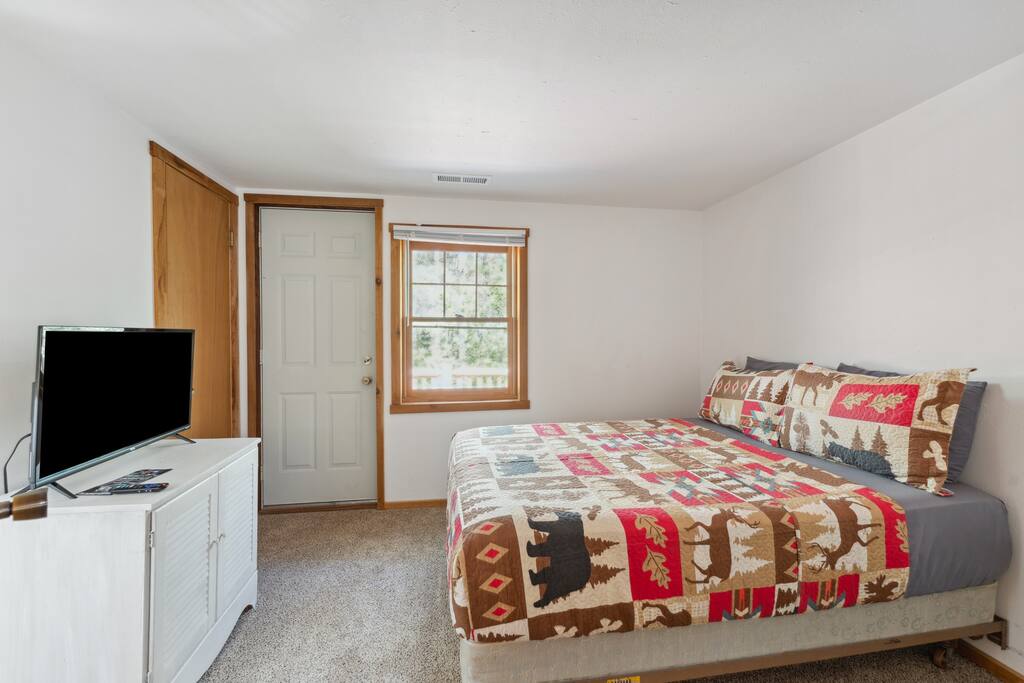 Upstairs lodge full bed includes Roku TV, dresser, alarm clock with USB charger, portable fan, extra pillow and blankets, closet with hangers, and access to the balcony. Upstairs lodge full bed includes Roku TV, dresser, alarm clock with USB charger, portable fan, extra pillow and blankets, closet with hangers, and access to the balcony. - Eagle Bluff Estate - Mauston
