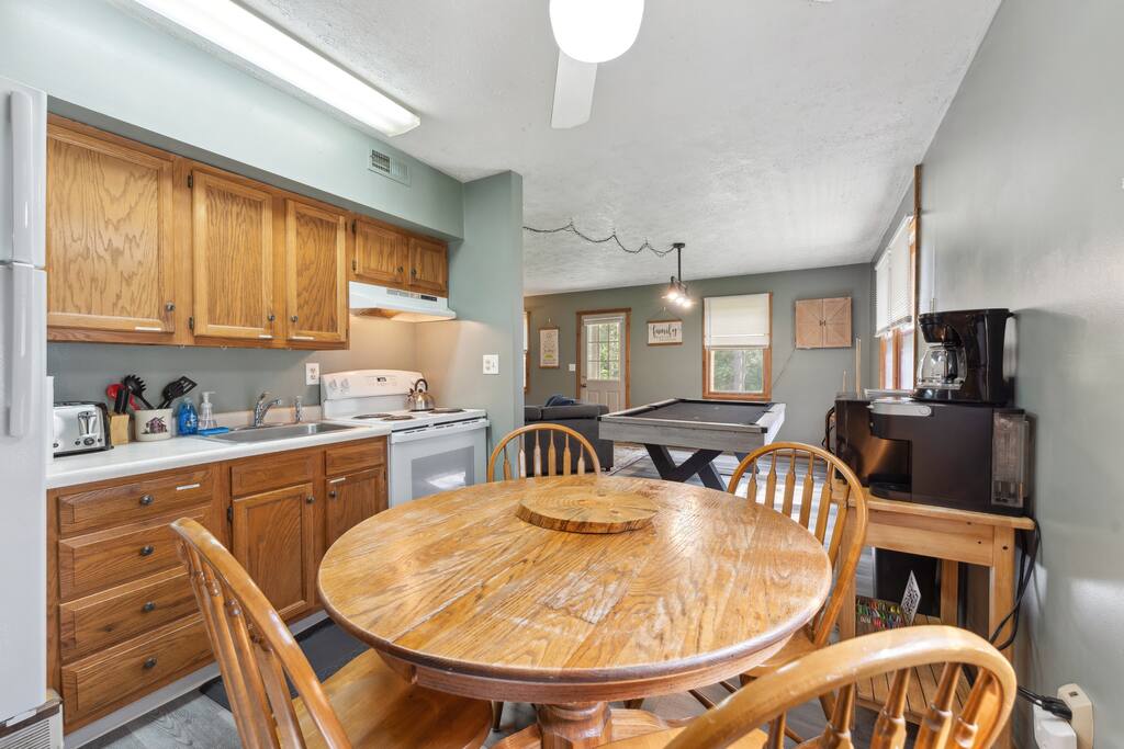 The cabin kitchen has a table and chairs. There is also a card table in the main-level bedroom closet. The cabin kitchen has a table and chairs. There is also a card table in the main-level bedroom closet. - Eagle Bluff Estate - Mauston