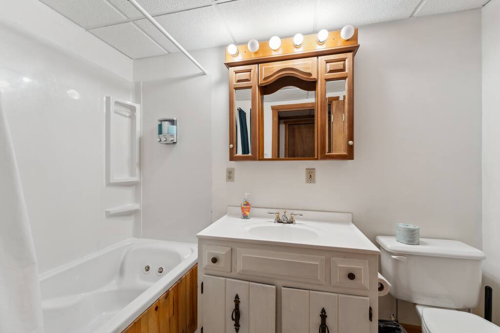 Lodge basement full bathroom with jetted tub/shower, shampoo, conditioner, body wash, soap, towels, washcloths, and extra towels. Lodge basement full bathroom with jetted tub/shower, shampoo, conditioner, body wash, soap, towels, washcloths, and extra towels. - Eagle Bluff Estate - Mauston