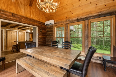 Rustic dining room with forest views and a spacious farmhouse table
