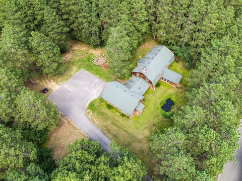 Secluded woodland retreat with fire pit, pond, and spacious yard