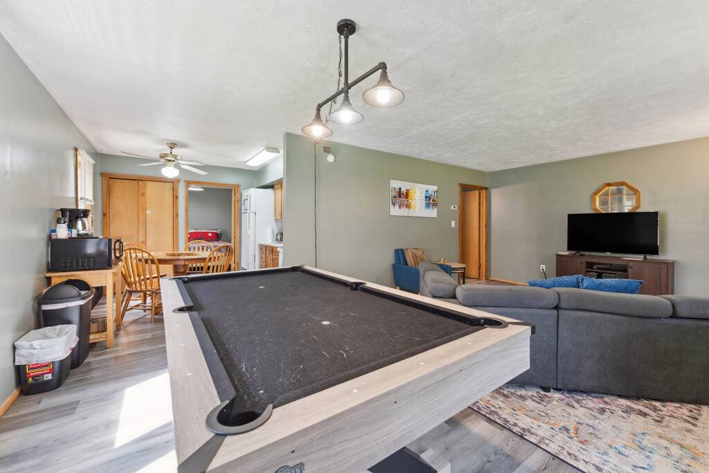 Cabin living room includes convertible full couch bed, Roku TV, fireplace, Blu-ray player with tons of dvd's, pool table, dart board, and plenty of seating. Cabin living room includes convertible full couch bed, Roku TV, fireplace, Blu-ray player with tons of dvd's, pool table, dart board, and plenty of seating. - Eagle Bluff Estate - Mauston