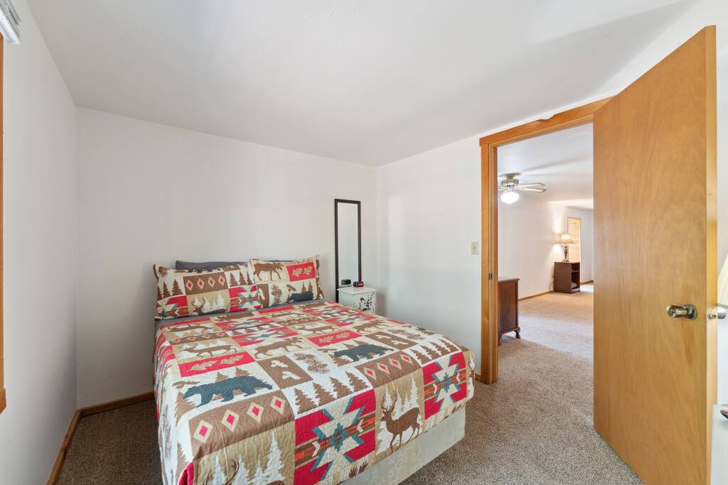 Upstairs lodge full bed includes Roku TV, dresser, alarm clock with USB charger, portable fan, extra pillow and blankets, closet with hangers, and access to the balcony. Upstairs lodge full bed includes Roku TV, dresser, alarm clock with USB charger, portable fan, extra pillow and blankets, closet with hangers, and access to the balcony. - Eagle Bluff Estate - Mauston