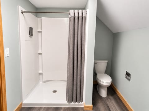 Bright modern bathroom with walk-in shower and clean, updated finishes