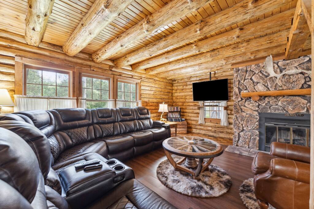 Living room of the lodge includes a leather sectional couch, Roku TV, wood burning fireplace, blu-ray plaer with tons of movies, additional recliner, and great decor. There is also a library with a variety of reading materials and new flooring. Living room of the lodge includes a leather sectional couch, Roku TV, wood burning fireplace, blu-ray plaer with tons of movies, additional recliner, and great decor. There is also a library with a variety of reading materials and new flooring. - Eagle Bluff Estate - Mauston