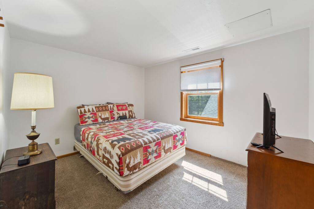 Upstairs lodge full bed includes Roku TV, dresser, alarm clock with USB charger, portable fan, extra pillow and blankets, and closet with hangers. Upstairs lodge full bed includes Roku TV, dresser, alarm clock with USB charger, portable fan, extra pillow and blankets, and closet with hangers. - Eagle Bluff Estate - Mauston