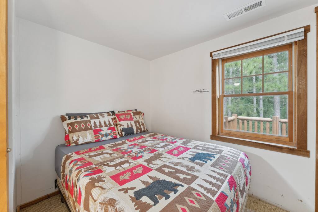 Upstairs lodge full bed includes Roku TV, dresser, alarm clock with USB charger, portable fan, extra pillow and blankets, closet with hangers, and access to the balcony. Upstairs lodge full bed includes Roku TV, dresser, alarm clock with USB charger, portable fan, extra pillow and blankets, closet with hangers, and access to the balcony. - Eagle Bluff Estate - Mauston